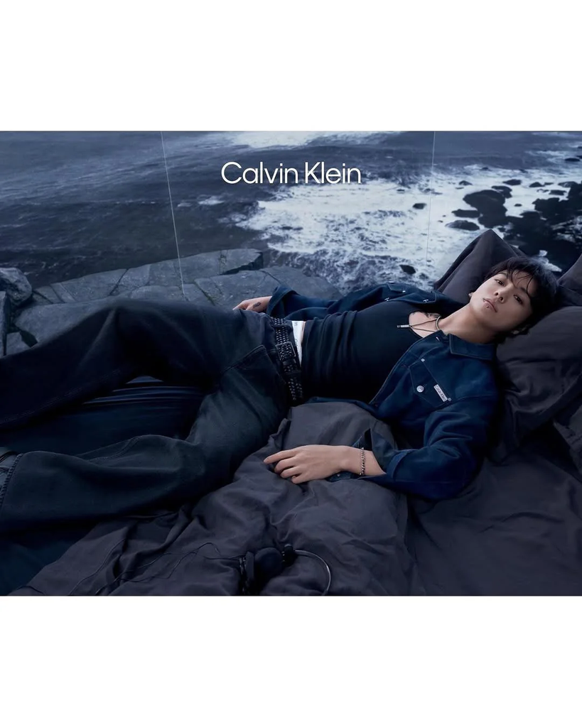 JK in an ad for Calvin Klein - he lounges with an ocean scene behind him.