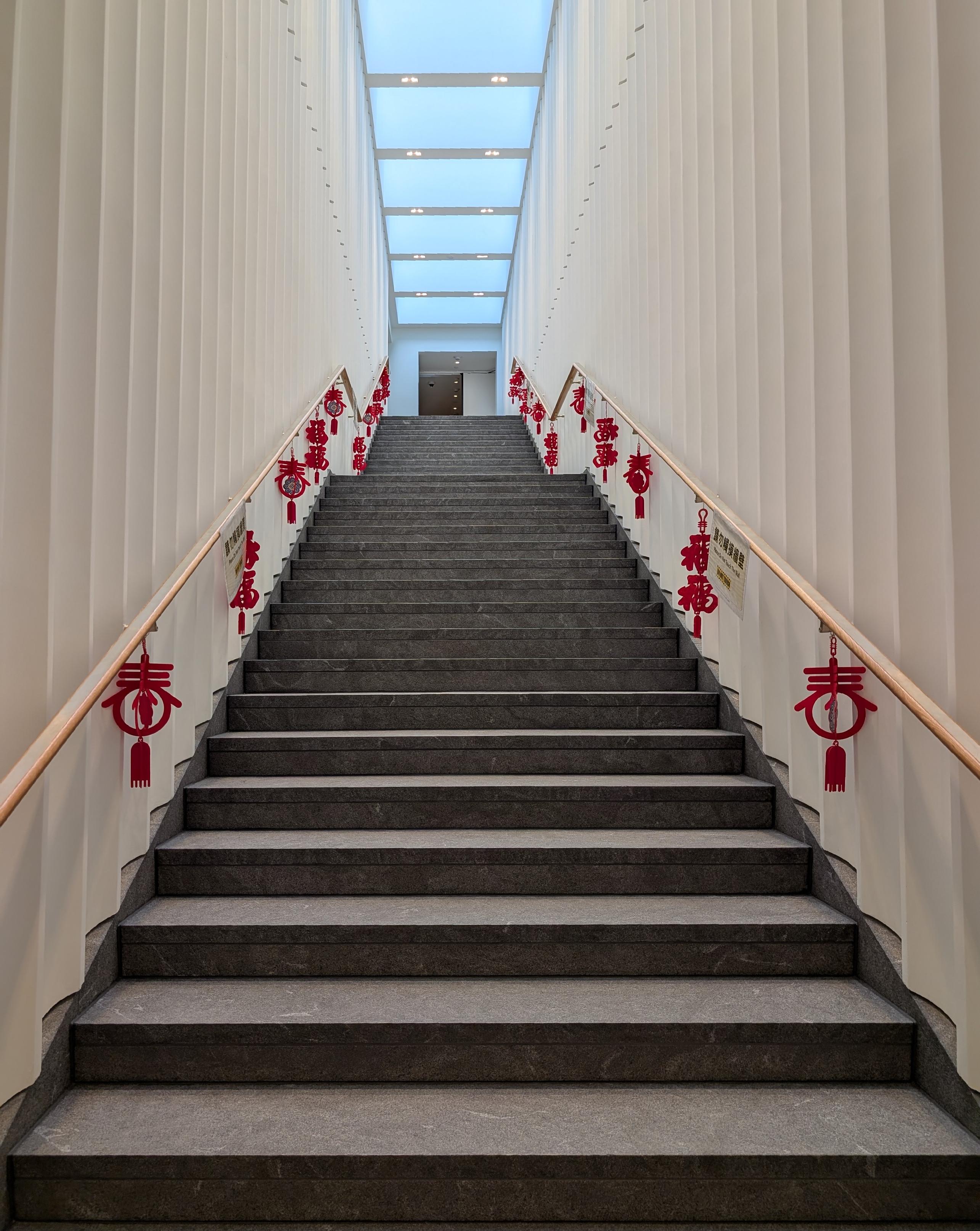 Very modern white and grey staircase with bright red New Year ornaments