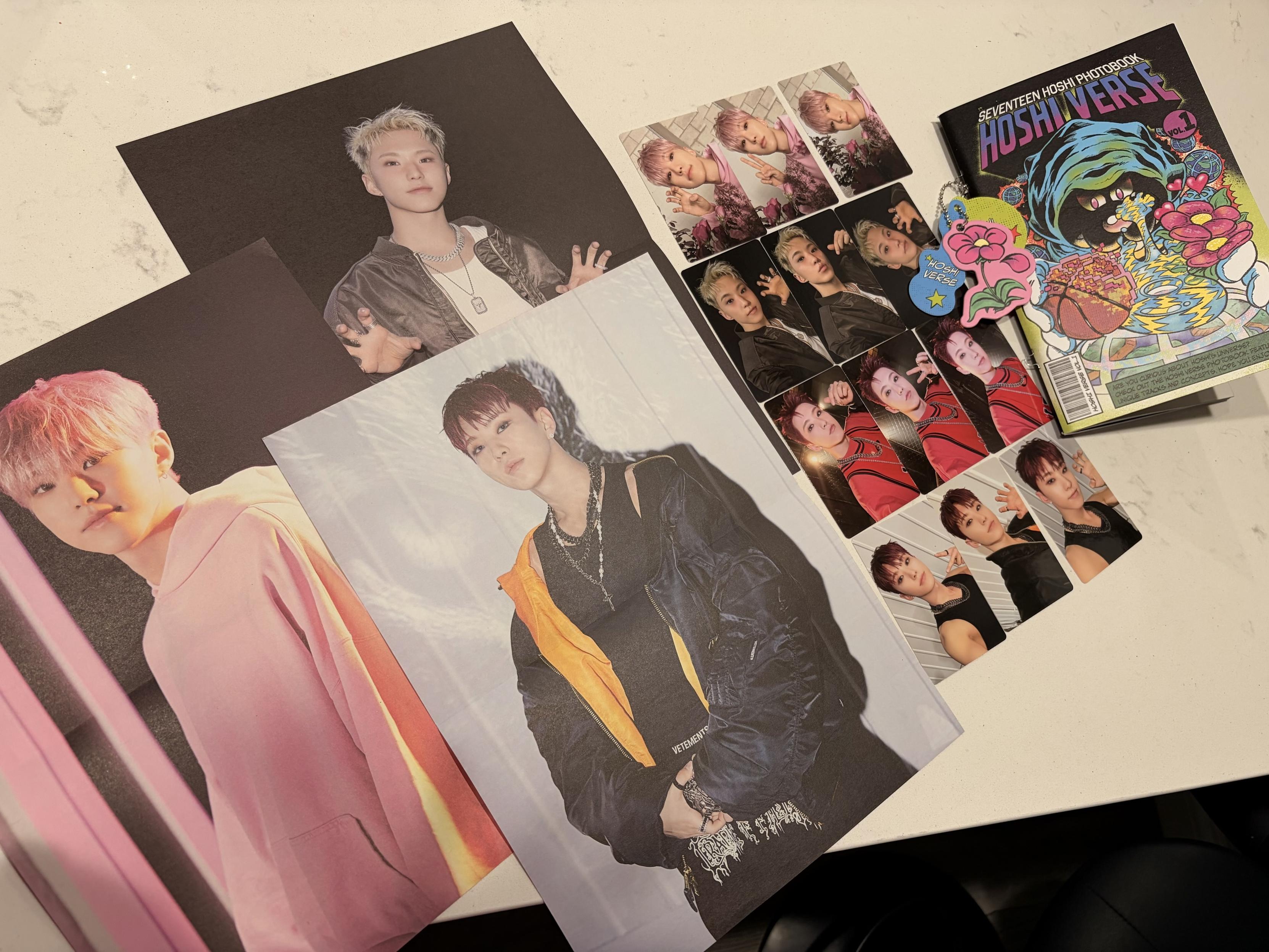 Photos of Hoshi from the photobook Hoshi Verse. The image shows 3 posters and 12 photocards.